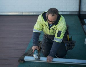 Man working on a roof of a building