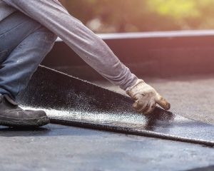 Man holding a roofing material